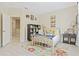 Cozy bedroom featuring a bed, colorful rug, decorative bookshelf, and natural light from the window at 3321 Messina Dr, Lake Mary, FL 32746