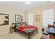 Bedroom with a red and black themed bed, computer desk, and light wood-look floors at 3321 Messina Dr, Lake Mary, FL 32746