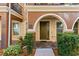 Inviting front entrance with manicured landscaping, dark brown door, and arched entry at 3321 Messina Dr, Lake Mary, FL 32746