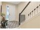 Bright foyer with staircase, light-colored walls, and a stylish area rug at 3321 Messina Dr, Lake Mary, FL 32746