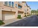 Exterior garages of townhomes with beige siding and manicured hedges at 3321 Messina Dr, Lake Mary, FL 32746