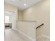 Upstairs hallway with natural light and wood-look floors, leading to a bedroom at 3321 Messina Dr, Lake Mary, FL 32746