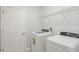 Bright laundry room equipped with a washer, dryer, and shelving for storage at 3321 Messina Dr, Lake Mary, FL 32746