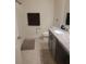 Cozy bathroom featuring granite counters and sleek gray cabinets with modern fixtures at 3342 Pink Oleander, Mascotte, FL 34753