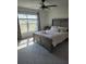 Sunlit bedroom featuring a plush bed with decorative pillows and a large window at 3342 Pink Oleander, Mascotte, FL 34753