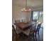 Elegant dining room with modern chandelier and a sliding glass door at 3342 Pink Oleander, Mascotte, FL 34753