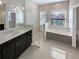 Modern bathroom featuring a glass shower, soaking tub, and dual vanity at 3447 Astoria Ct, Winter Park, FL 32792