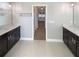 Bathroom with dual vanities, modern fixtures, and a doorway leading to the bedroom at 3447 Astoria Ct, Winter Park, FL 32792