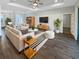 Bright living room boasts wood floors, modern furniture, and a cozy atmosphere, perfect for relaxing or entertaining guests at 3447 Astoria Ct, Winter Park, FL 32792