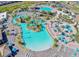 Aerial view of a resort-style pool with beach chairs, landscaping, and various amenities at 351 Ocean Course Ave, Davenport, FL 33896