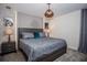 Serene bedroom boasts stone accent wall, soft lighting, and calming grey tones at 351 Ocean Course Ave, Davenport, FL 33896