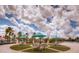 Community courtyard area with shaded tables, chairs, and a fountain at 351 Ocean Course Ave, Davenport, FL 33896