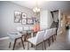 Elegant dining room featuring a modern chandelier, glass-top table, and contemporary decor at 351 Ocean Course Ave, Davenport, FL 33896