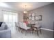 Inviting dining room featuring a modern chandelier, glass-top table, and serene atmosphere at 351 Ocean Course Ave, Davenport, FL 33896