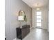 Elegant entryway featuring a modern console table, decorative mirror, and stylish pendant lighting at 351 Ocean Course Ave, Davenport, FL 33896