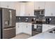 Well-equipped kitchen featuring stainless steel appliances, white cabinetry, and sleek countertops at 351 Ocean Course Ave, Davenport, FL 33896