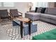 Living room featuring a gray sectional sofa, chairs, and a modern accent rug at 351 Ocean Course Ave, Davenport, FL 33896