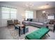 Bright living room with a gray sectional sofa, patterned rug, and modern lighting fixtures at 351 Ocean Course Ave, Davenport, FL 33896