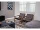 A cozy living room featuring two armchairs, a modern rug, and contemporary decor at 351 Ocean Course Ave, Davenport, FL 33896