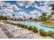 Large community pool with beach chairs and lush landscaping at 351 Ocean Course Ave, Davenport, FL 33896