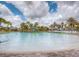 Expansive community pool featuring a shallow end and palm tree landscaping at 351 Ocean Course Ave, Davenport, FL 33896