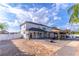 A stunning back exterior showcasing a large, paved yard, fire pit, outdoor seating beneath a pergola, and pristine white fencing at 352 Radisson Pl, Oviedo, FL 32765