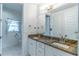 Bathroom featuring granite countertop, double sinks, and a window for natural light at 352 Radisson Pl, Oviedo, FL 32765