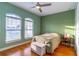 Inviting bedroom with arched windows, wood floors, and a ceiling fan at 352 Radisson Pl, Oviedo, FL 32765