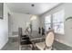 Dining room featuring a large, modern table and chairs, plus a stylish chandelier at 352 Radisson Pl, Oviedo, FL 32765