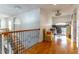 Bright hallway with an office setup visible with hardwood floors and decorative railing at 352 Radisson Pl, Oviedo, FL 32765