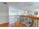 Bright hallway with hardwood floors and decorative railings on staircase at 352 Radisson Pl, Oviedo, FL 32765