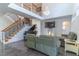 Spacious living room with a staircase, piano, and elegant chandelier at 352 Radisson Pl, Oviedo, FL 32765