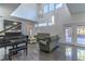 Bright living room featuring high ceilings, a grand piano, and comfortable seating at 352 Radisson Pl, Oviedo, FL 32765