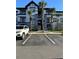 Well-maintained condo building with palm trees, parking and a modern facade at 3701 Castle Pines Ln # 3923, Orlando, FL 32839