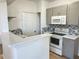 Charming kitchen with gray cabinetry, quartz countertops, and backsplash at 3701 Castle Pines Ln # 3923, Orlando, FL 32839