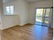 Bright living room featuring wood-look floors and sliding glass doors to balcony at 3701 Castle Pines Ln # 3923, Orlando, FL 32839