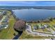 Aerial view of the neighborhood and lake featuring community amenities in the background at 4228 Sunset Preserve Blvd, Orlando, FL 32820