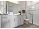 Bathroom featuring double sinks, a glass shower, and modern white cabinets at 4228 Sunset Preserve Blvd, Orlando, FL 32820