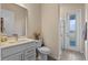 Bathroom featuring white cabinets, a shower, and bright natural light at 4228 Sunset Preserve Blvd, Orlando, FL 32820