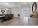 Elegant dining room featuring wood-look flooring, a modern chandelier, and stylish decor at 4228 Sunset Preserve Blvd, Orlando, FL 32820