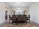 Bright dining room with a modern chandelier, decorative mirrors, and an elegant rug at 4228 Sunset Preserve Blvd, Orlando, FL 32820