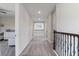 Bright hallway featuring neutral walls, carpet floor, and decorative railing at 4228 Sunset Preserve Blvd, Orlando, FL 32820