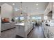 Modern kitchen with stainless steel appliances, white backsplash and a center island with seating at 4228 Sunset Preserve Blvd, Orlando, FL 32820