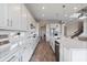 Modern kitchen with white cabinets, sleek countertops, stainless steel appliances, and wood-look flooring at 4228 Sunset Preserve Blvd, Orlando, FL 32820