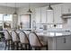 Modern kitchen with stainless steel appliances, white backsplash and a center island with seating at 4228 Sunset Preserve Blvd, Orlando, FL 32820