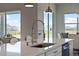 Close-up of kitchen sink with stainless steel appliances, white countertop, and bright windows at 4228 Sunset Preserve Blvd, Orlando, FL 32820