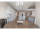 Spacious kitchen with white cabinets, stainless steel appliances, island, and a view of a staircase to the second level at 4228 Sunset Preserve Blvd, Orlando, FL 32820