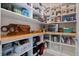 Well-organized pantry with wooden countertops, wire baskets, a variety of food items, and a small appliance at 4228 Sunset Preserve Blvd, Orlando, FL 32820