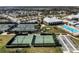 Aerial view showcasing tennis courts, bocce ball, a pool, and clubhouse amenities in a vibrant community setting at 4909 Drawdy Ct, St Cloud, FL 34772