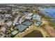 Aerial view featuring tennis courts, a basketball court, clubhouse, and pool, with lakes in the background at 4909 Drawdy Ct, St Cloud, FL 34772